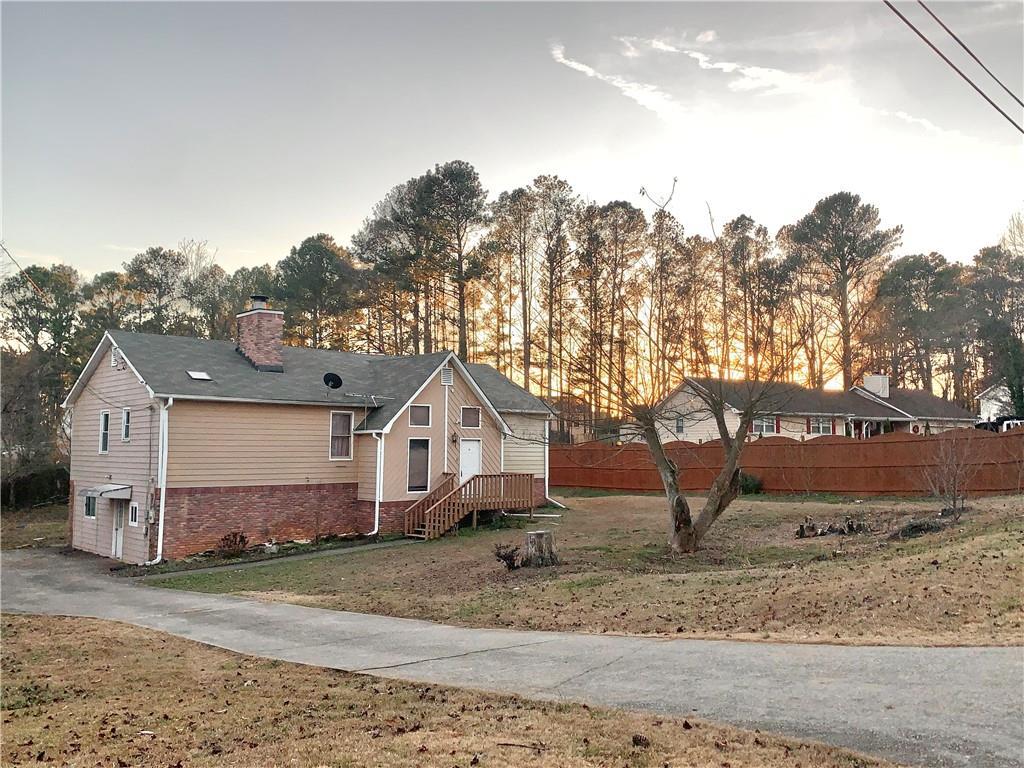 view of property exterior featuring a lawn