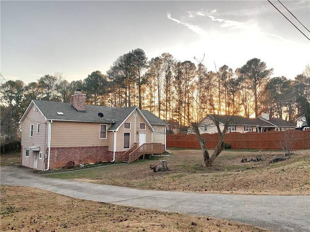 view of property exterior featuring a lawn