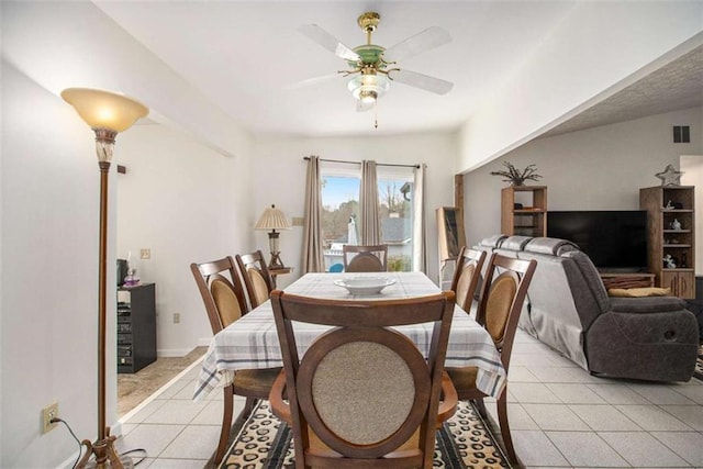 tiled dining room featuring ceiling fan