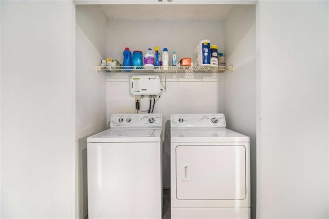 clothes washing area with washing machine and dryer