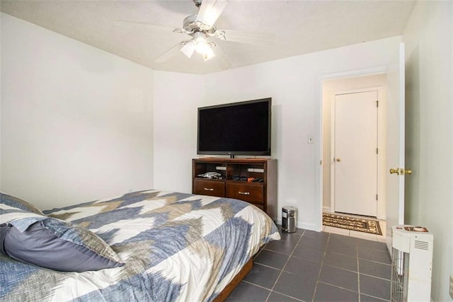 tiled bedroom featuring ceiling fan