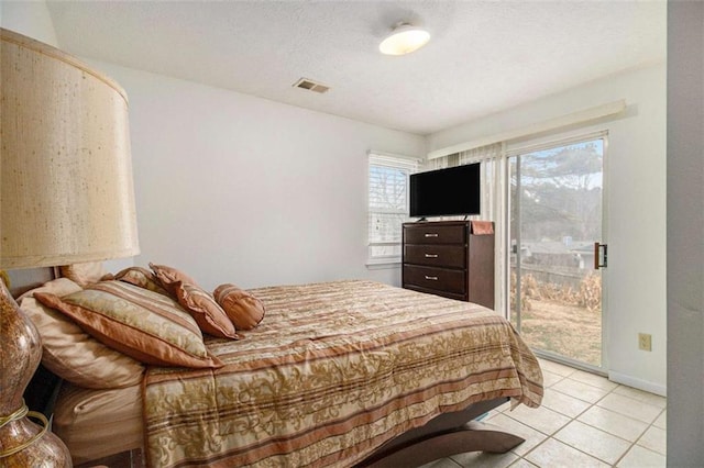 bedroom with light tile patterned floors