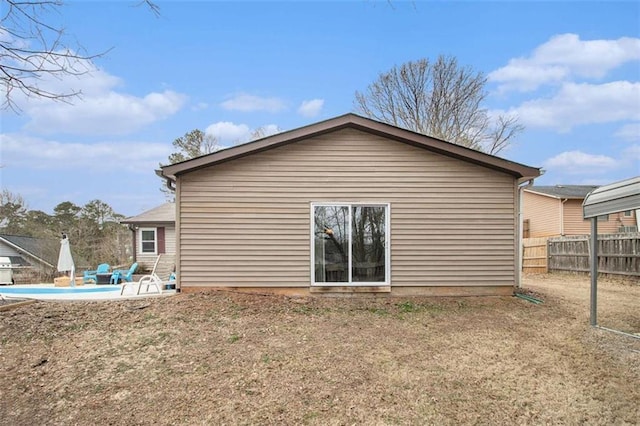 back of house with a patio area and a lawn