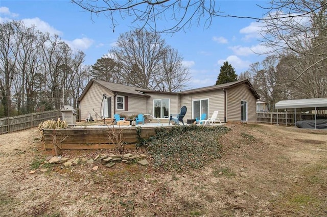 back of property with a carport