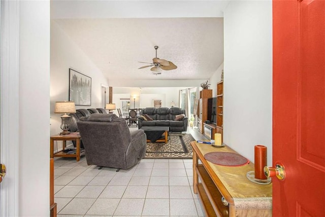 tiled living room with vaulted ceiling and ceiling fan