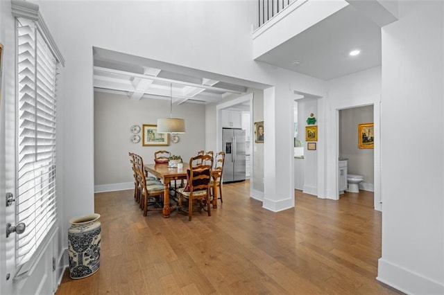 352 Davis St, Monroe, GA 30655 - dining space with baseboards, wood finished floors, beam ceiling, and coffered ceiling