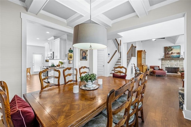 352 Davis St, Monroe, GA 30655 - dining room with a fireplace, dark wood finished floors, stairs, coffered ceiling, and beam ceiling