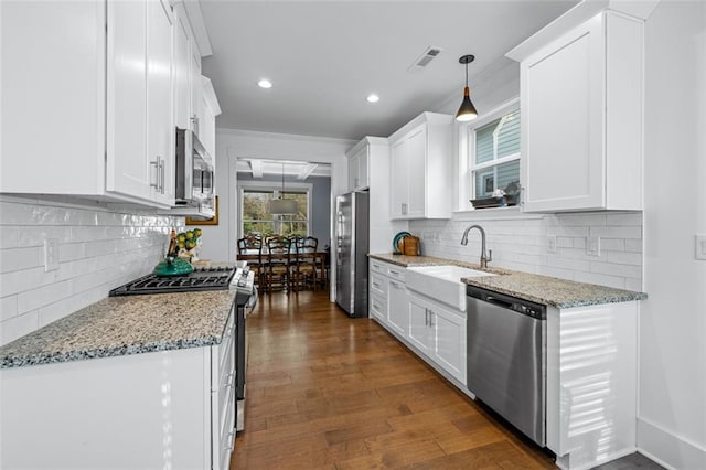 352 Davis St, Monroe, GA 30655 - kitchen with light stone countertops, white cabinets, a sink, stainless steel appliances, and dark wood-style floors