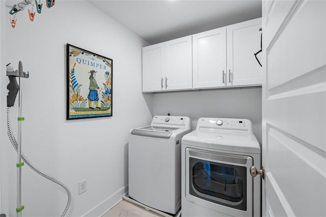352 Davis St, Monroe, GA 30655 - clothes washing area featuring baseboards, washing machine and clothes dryer, and cabinet space