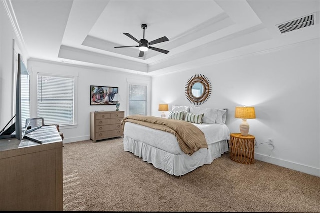 352 Davis St, Monroe, GA 30655 - bedroom featuring ceiling fan, a tray ceiling, visible vents, carpet flooring, and baseboards