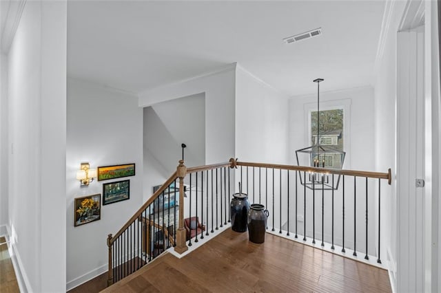 352 Davis St, Monroe, GA 30655 - hallway with visible vents, baseboards, an upstairs landing, crown molding, and wood finished floors