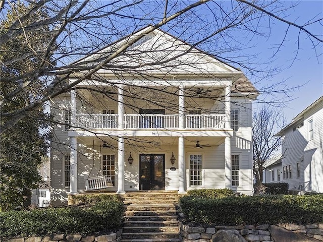 neoclassical / greek revival house with a balcony and covered porch