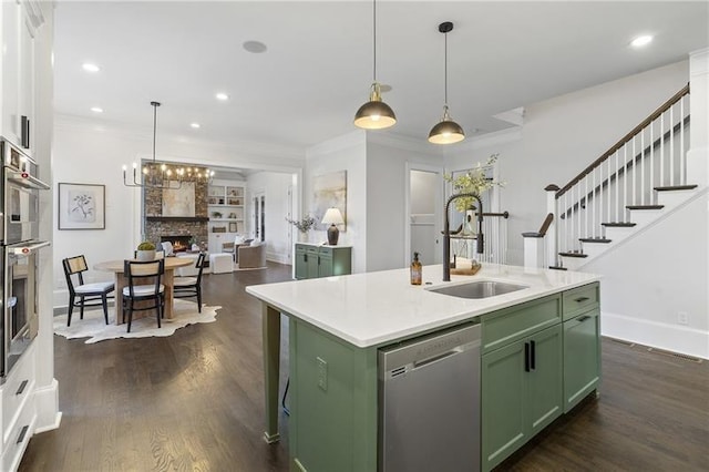 kitchen with sink, white cabinetry, a center island with sink, appliances with stainless steel finishes, and green cabinets