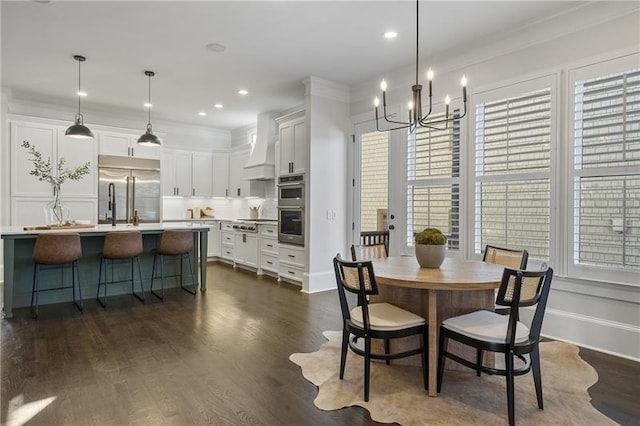 dining area featuring an inviting chandelier, plenty of natural light, ornamental molding, and dark hardwood / wood-style floors