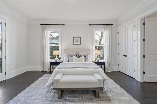 bedroom with crown molding, dark hardwood / wood-style floors, and multiple windows