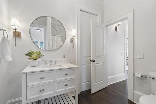 bathroom with vanity, curtained shower, wood-type flooring, and toilet