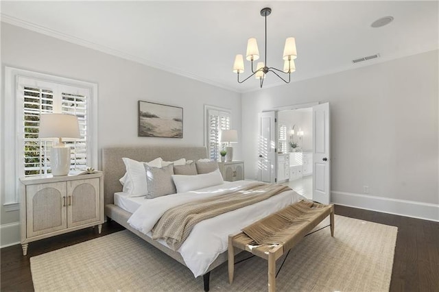 bedroom with an inviting chandelier, crown molding, ensuite bath, and dark hardwood / wood-style floors