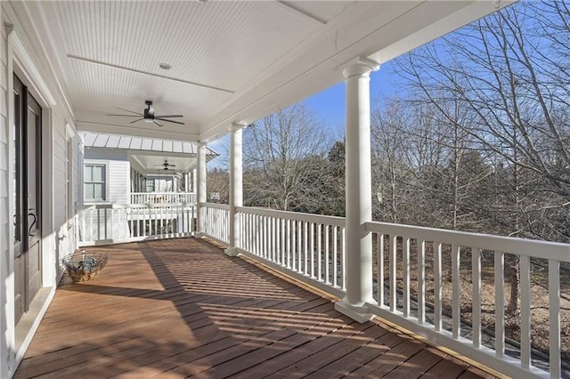 wooden terrace featuring covered porch and ceiling fan