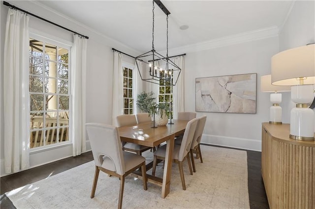 dining room featuring an inviting chandelier, hardwood / wood-style flooring, and ornamental molding