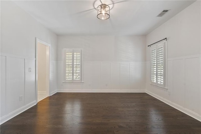 empty room with dark hardwood / wood-style floors