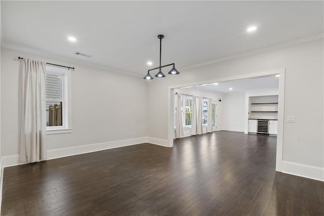 unfurnished living room featuring ornamental molding and dark hardwood / wood-style floors