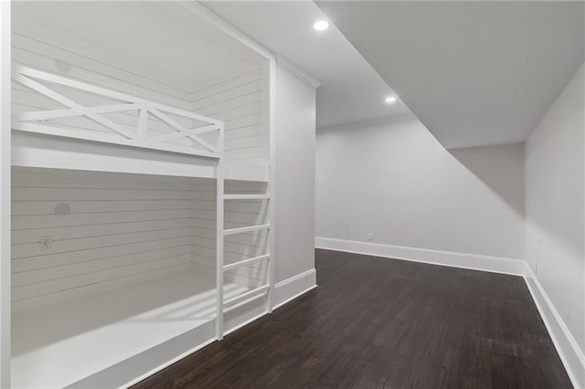 additional living space with dark wood-type flooring