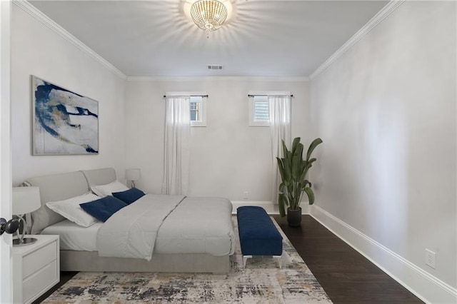 bedroom with crown molding and dark hardwood / wood-style floors