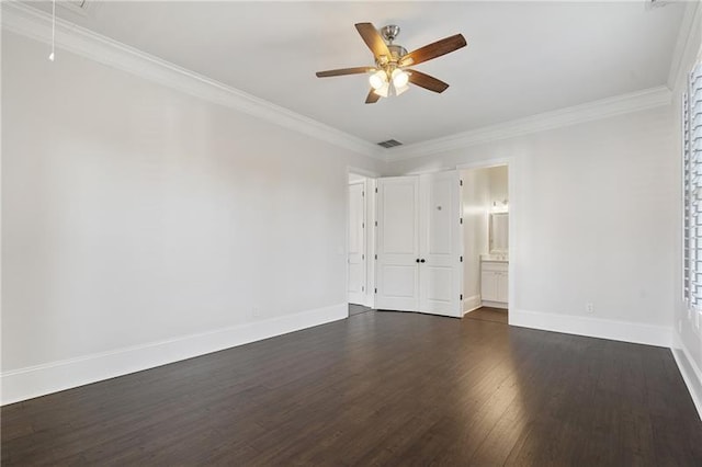 empty room featuring crown molding, dark hardwood / wood-style floors, and ceiling fan