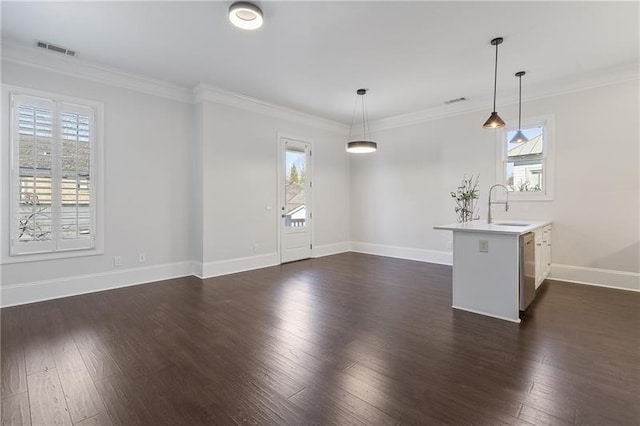 spare room with dark wood-type flooring, plenty of natural light, and crown molding