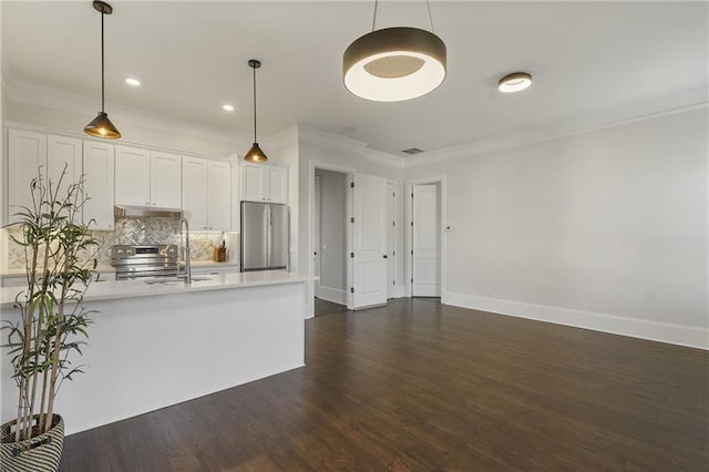 kitchen featuring dark wood-type flooring, white cabinetry, decorative light fixtures, appliances with stainless steel finishes, and decorative backsplash