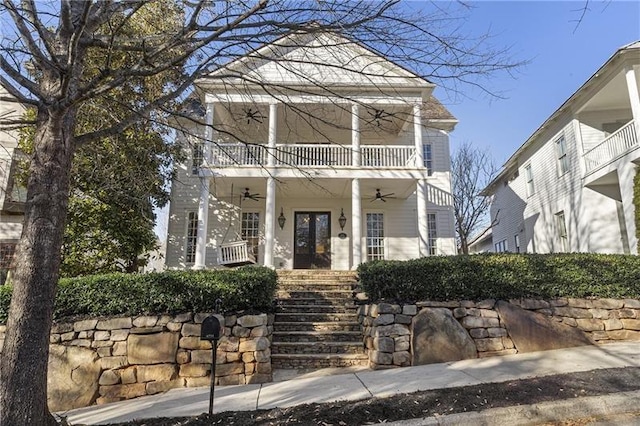 greek revival house featuring ceiling fan and a balcony