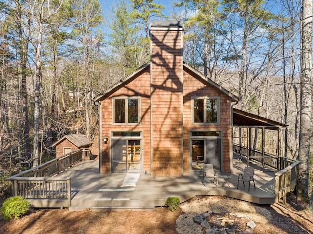 exterior space featuring a chimney and a wooden deck