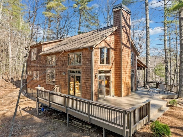 exterior space featuring a chimney and a wooden deck