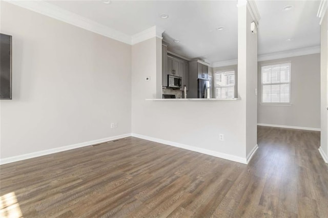 unfurnished living room with baseboards, ornamental molding, and dark wood finished floors