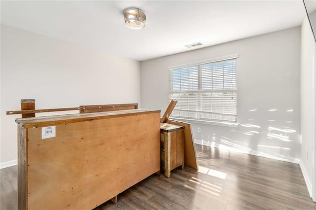 bar featuring wood finished floors, visible vents, and baseboards