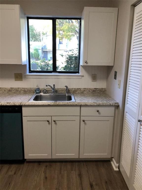 kitchen featuring dark hardwood / wood-style floors, dishwasher, sink, and white cabinets