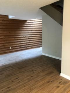 additional living space featuring dark wood-type flooring