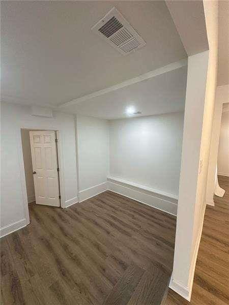 2041 Olive Springs Rd, Marietta, GA 30060 - basement featuring baseboards, visible vents, and wood finished floors