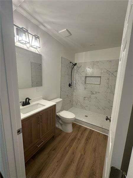 2041 Olive Springs Rd, Marietta, GA 30060 - bathroom featuring vanity, toilet, wood finished floors, and a shower stall