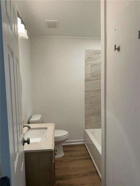 2041 Olive Springs Rd, Marietta, GA 30060 - bathroom with toilet, visible vents, wood finished floors, and vanity