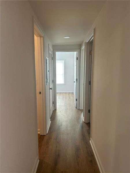 2041 Olive Springs Rd, Marietta, GA 30060 - hallway featuring dark wood finished floors and baseboards