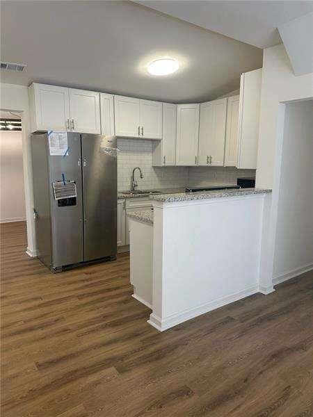 2041 Olive Springs Rd, Marietta, GA 30060 - kitchen featuring stainless steel fridge with ice dispenser, white cabinetry, dark wood finished floors, and a sink