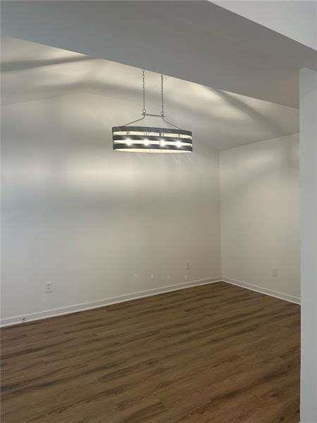 2041 Olive Springs Rd, Marietta, GA 30060 - unfurnished dining area with dark wood-style flooring and baseboards