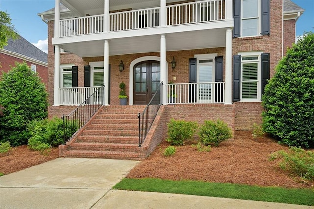 230 Summerhouse Ln, Atlanta, GA 30350 - property entrance featuring a balcony, covered porch, and brick siding