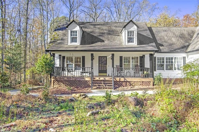 cape cod home featuring a porch