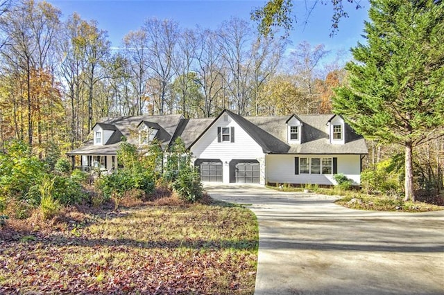 cape cod house featuring a garage