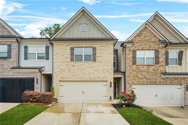 townhome / multi-family property featuring concrete driveway, board and batten siding, and an attached garage