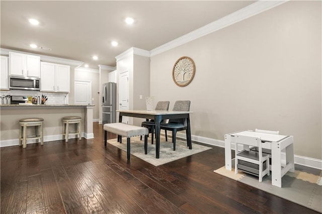 dining area with baseboards, ornamental molding, and dark wood finished floors