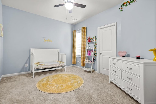 bedroom featuring baseboards, light carpet, and visible vents