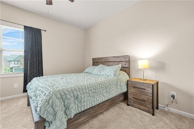 bedroom featuring baseboards, ceiling fan, and light carpet